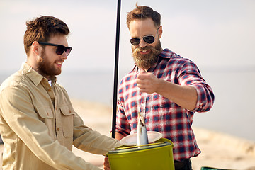 Image showing friends with fish, bucket and fishing rod on pier