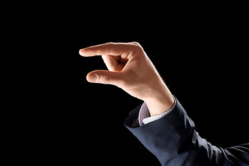 Image showing hand of businessman holding something imaginary