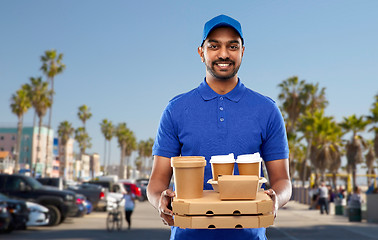 Image showing happy indian delivery man with food and drinks