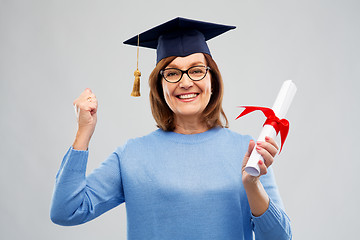 Image showing happy senior graduate student woman with diploma