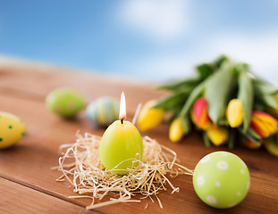 Image showing candle in shape of easter eggs and tulip flowers