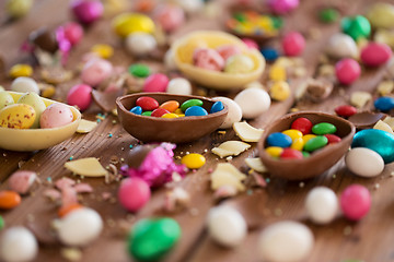 Image showing chocolate eggs and candy drops on wooden table