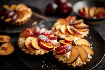 Image showing Delicious homemade mini tarts with fresh sliced plum fruit