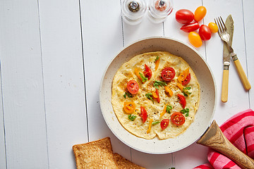 Image showing Tasty homemade classic omelet with cherry tomatoes