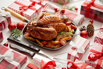 Image showing Roasted whole chicken or turkey served in iron pan with Christmas decoration