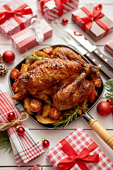 Image showing Roasted whole chicken or turkey served in iron pan with Christmas decoration