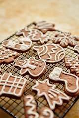 Image showing Fresh baked Christmas shaped gingerbread cookies placed on steel grill