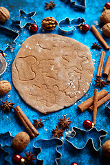 Image showing Christmas baking concept. Gingerbread dough with different cutter shapes