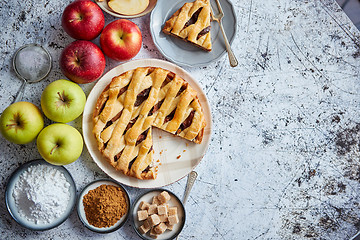 Image showing Delicious apple pie cake with a fresh fruits, brown and powder sugar