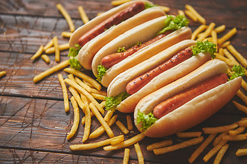 Image showing American hot dogs assorted in row. Served with french fries