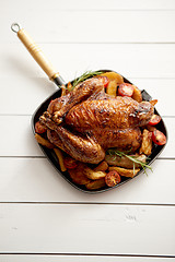 Image showing Roasted whole chicken in cast iron black pan