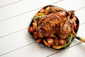 Image showing Roasted whole chicken in cast iron black pan