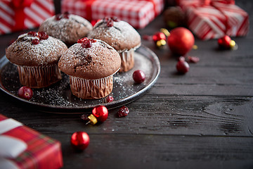 Image showing Christmas chocolate delicious muffins served on black ceramic plate