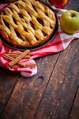 Image showing Homemade pastry apple pie with bakery products on dark wooden kitchen table