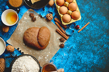 Image showing Gingerbread dough placed among various ingredients. Christmas baking concept