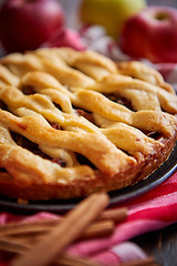 Image showing Homemade pastry apple pie with bakery products on dark wooden kitchen table