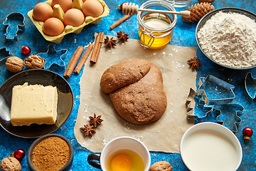 Image showing Gingerbread dough placed among various ingredients. Christmas baking concept