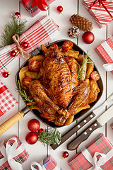 Image showing Roasted whole chicken or turkey served in iron pan with Christmas decoration