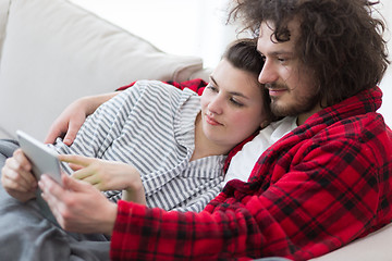 Image showing couple relaxing at  home with tablet computers