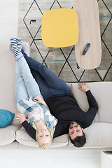 Image showing Young couple on the sofa watching television top view