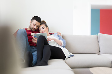 Image showing couple relaxing at  home with tablet computers