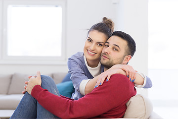 Image showing couple hugging and relaxing on sofa