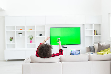 Image showing young man in bathrobe enjoying free time