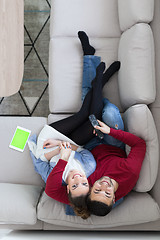 Image showing Young couple on the sofa watching television top view