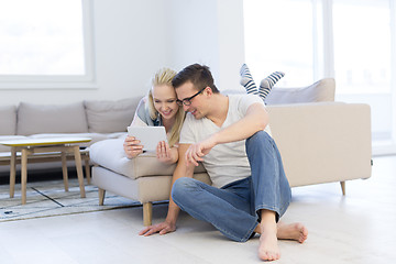 Image showing couple relaxing at  home with tablet computers