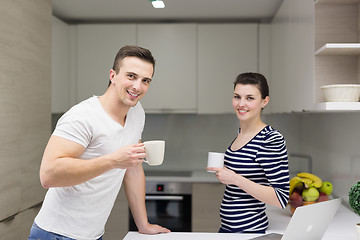 Image showing couple with laptop computer enjoying morning