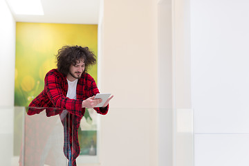 Image showing young freelancer using tablet computer