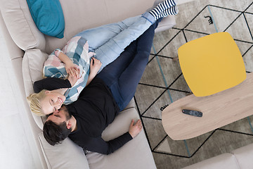 Image showing Young couple on the sofa watching television top view