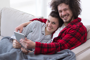 Image showing couple relaxing at  home with tablet computers