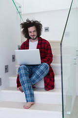 Image showing freelancer in bathrobe working from home