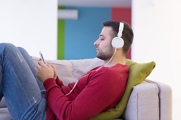 Image showing man enjoying music through headphones