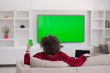 Image showing young man in bathrobe enjoying free time