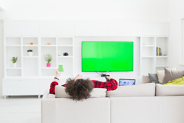 Image showing young man in bathrobe enjoying free time