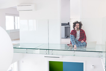 Image showing young freelancer in bathrobe working from home