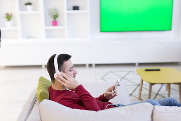 Image showing man enjoying music through headphones