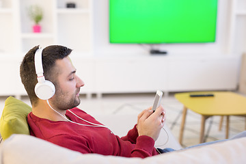 Image showing man enjoying music through headphones