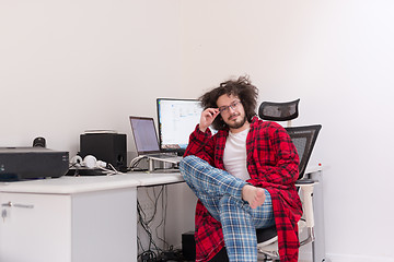 Image showing graphic designer in bathrobe working at home