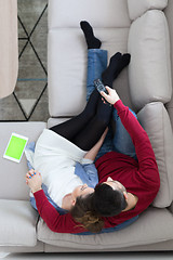 Image showing Young couple on the sofa watching television top view