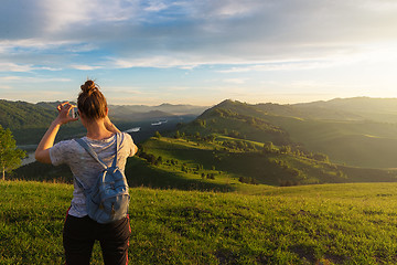 Image showing Woman taking photo in mountain