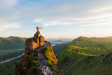 Image showing Man standing on top of cliff