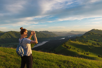 Image showing Woman taking photo in mountain