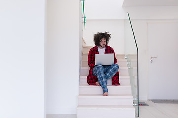 Image showing freelancer in bathrobe working from home