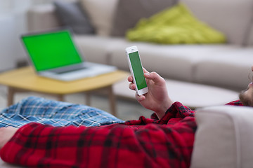 Image showing young man in bathrobe enjoying free time