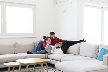 Image showing couple relaxing at  home with tablet computers