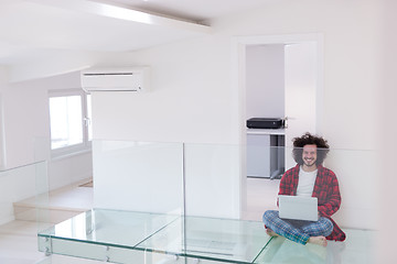 Image showing young freelancer in bathrobe working from home