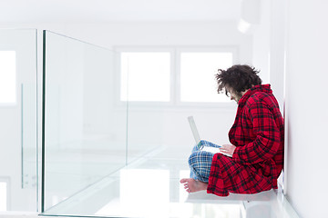 Image showing young freelancer in bathrobe working from home